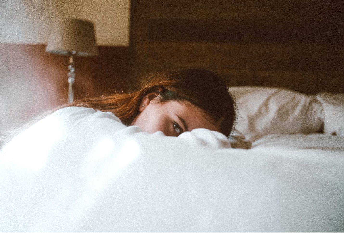 London escort in bed, looking at you romantically