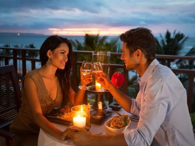 A couple enjoying a romantic dinner on the beach 