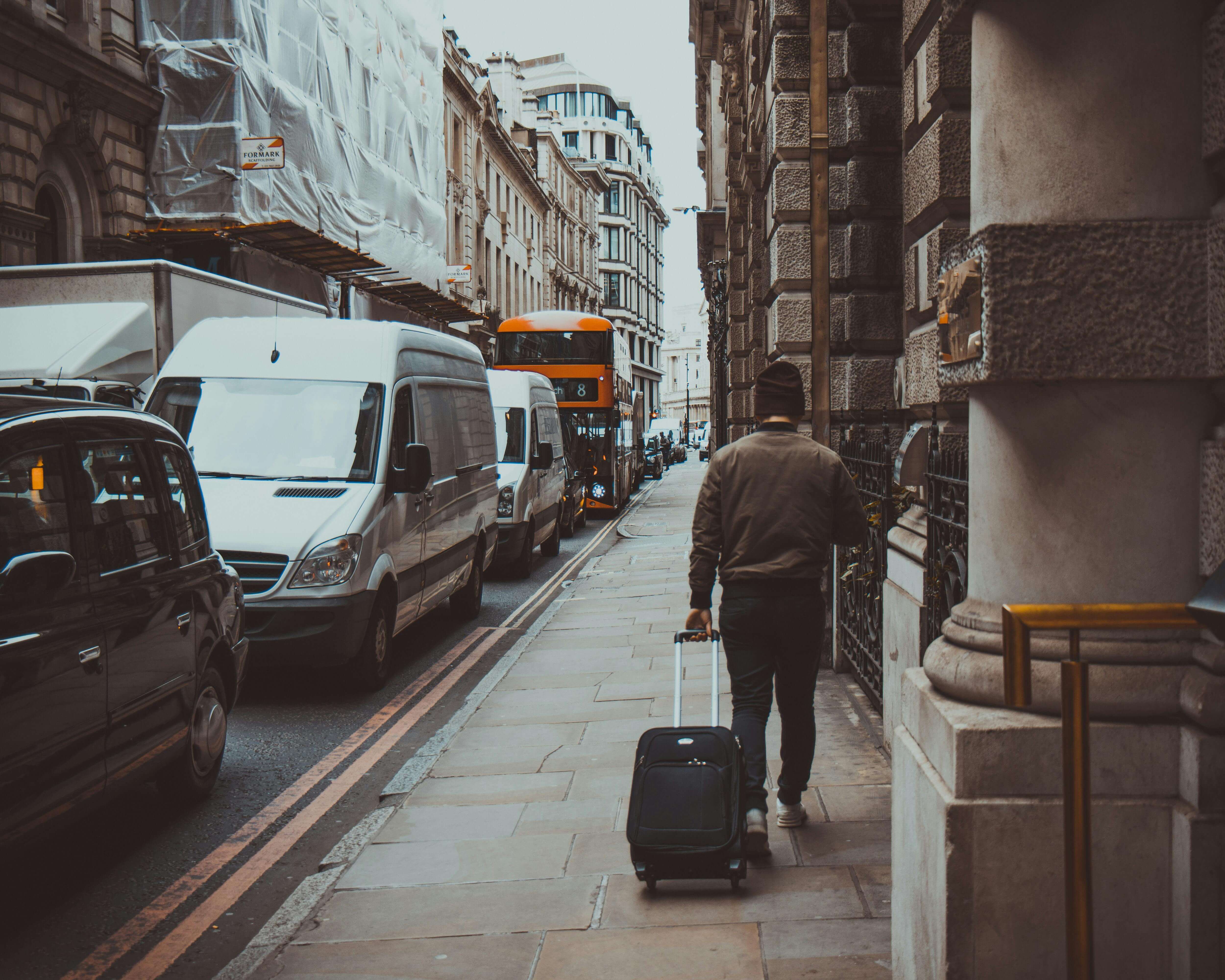a man with a suitcase on a London street