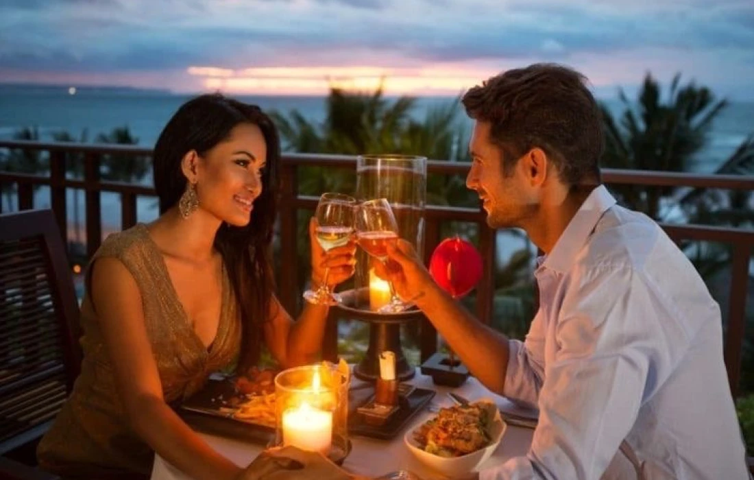 A couple enjoying a romantic dinner on the beach 