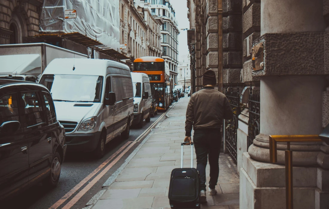 a man with a suitcase on a London street